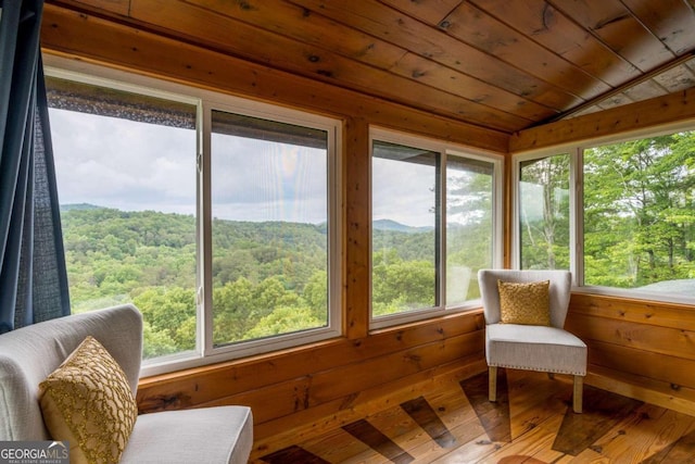 sunroom / solarium with plenty of natural light, wood ceiling, and vaulted ceiling