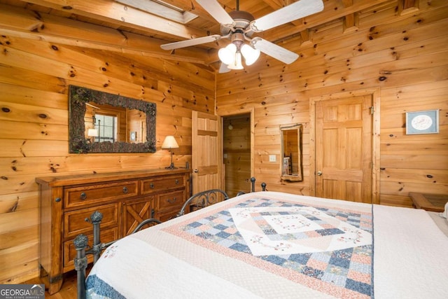 bedroom featuring beamed ceiling, wood walls, and ceiling fan