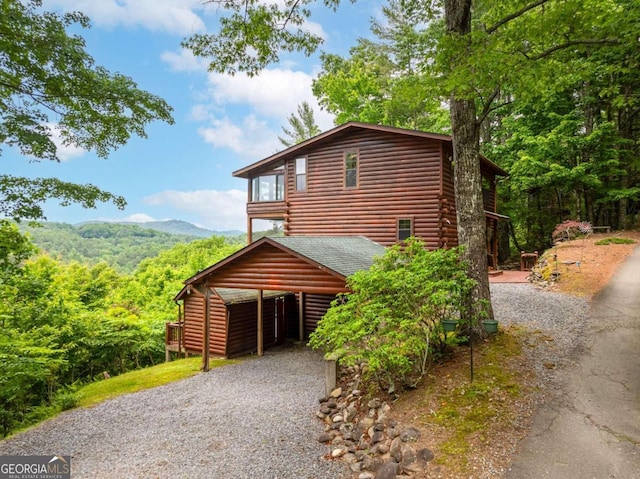 view of home's exterior featuring a mountain view and a carport