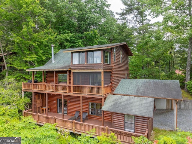 rear view of property with a wooden deck