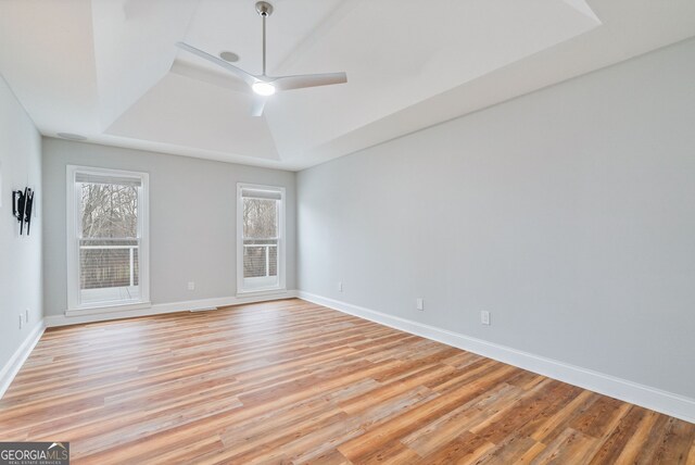 kitchen with appliances with stainless steel finishes, sink, light hardwood / wood-style floors, a breakfast bar, and wall chimney exhaust hood