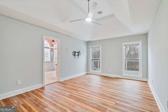 kitchen with stainless steel appliances, sink, a breakfast bar area, wall chimney range hood, and light wood-type flooring