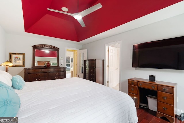 bedroom featuring dark wood-type flooring, ceiling fan, a raised ceiling, and lofted ceiling