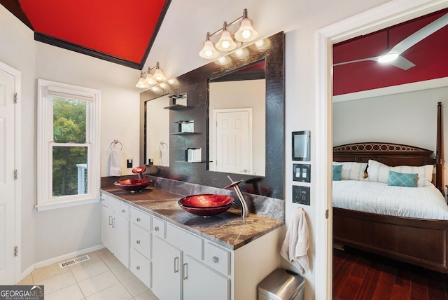 bathroom featuring hardwood / wood-style floors, lofted ceiling, and vanity