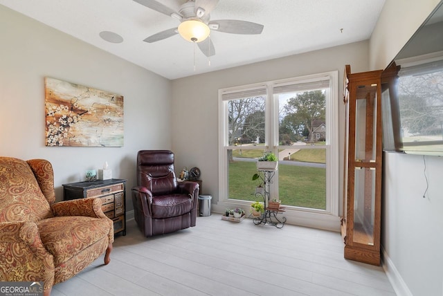 sitting room featuring ceiling fan and light hardwood / wood-style flooring