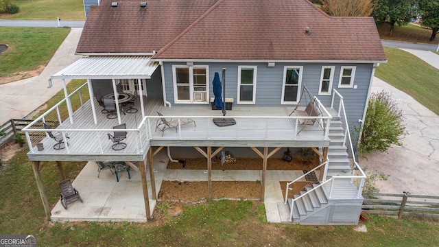 rear view of house with a patio area and a lawn