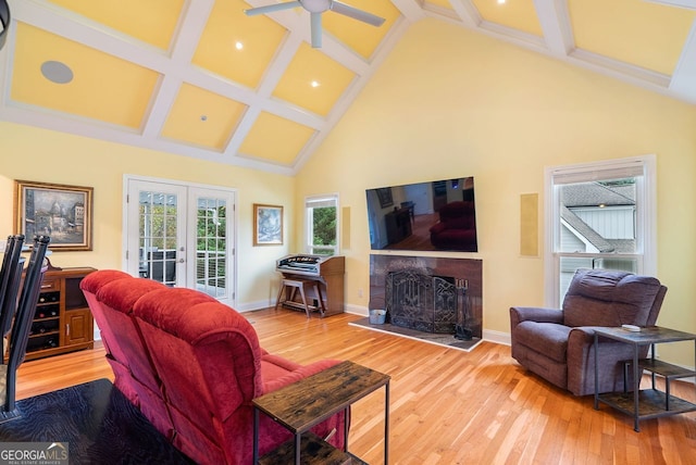 living room with ceiling fan, beam ceiling, high vaulted ceiling, hardwood / wood-style floors, and french doors