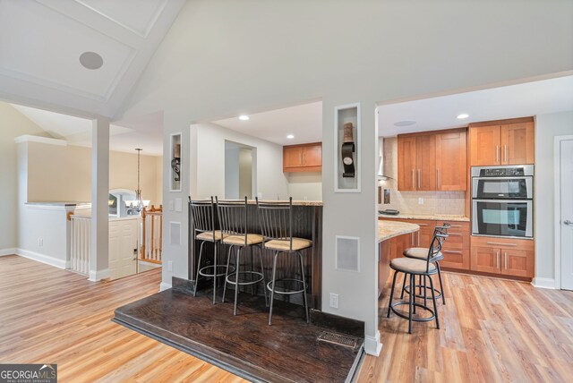 living room featuring beamed ceiling, wood-type flooring, high vaulted ceiling, and coffered ceiling