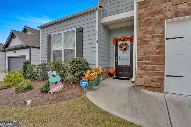 view of exterior entry with a garage