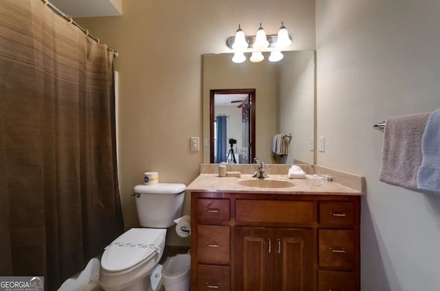 bathroom with toilet, vanity, and walk in shower