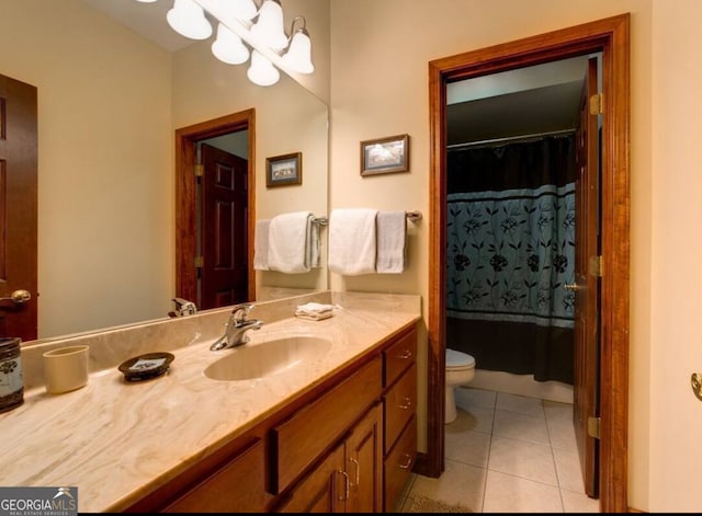 bathroom with tile patterned flooring, vanity, and toilet