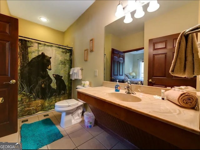 bathroom with toilet, vanity, a shower with shower curtain, and tile patterned floors