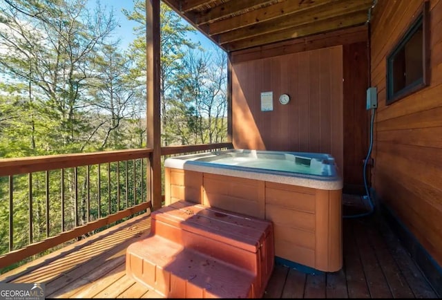 wooden deck featuring a hot tub