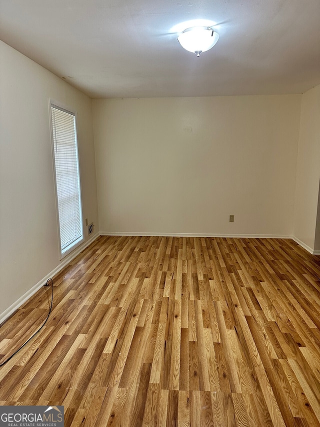 spare room with light hardwood / wood-style floors