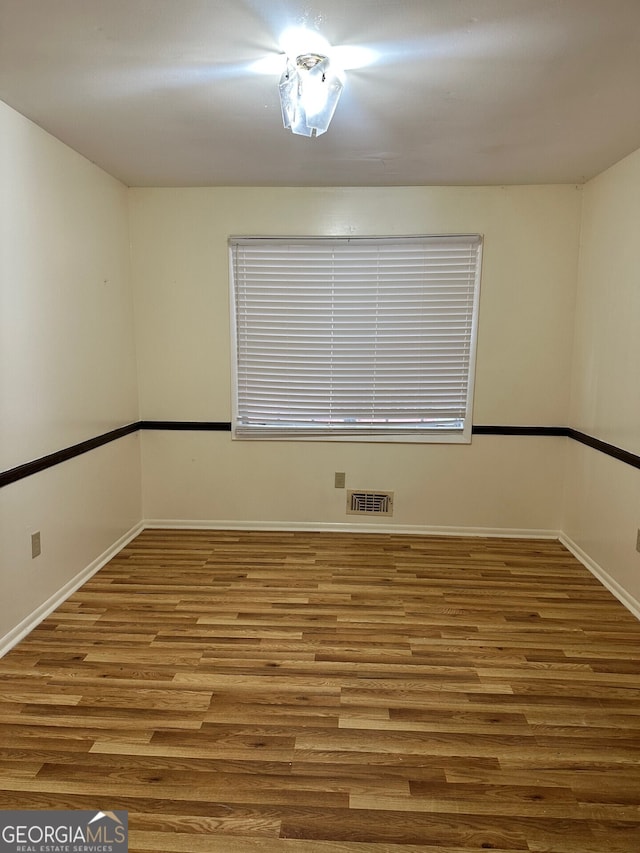 empty room featuring wood-type flooring