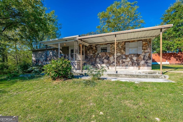 rear view of house with a lawn and covered porch