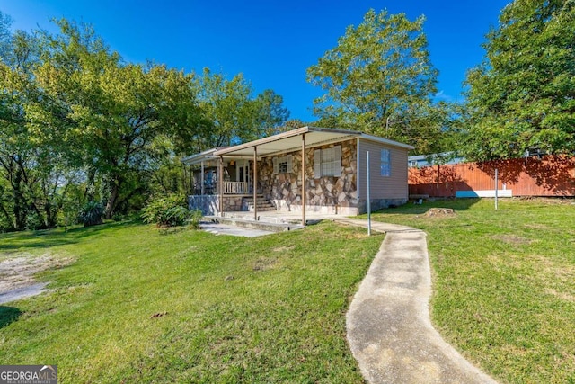 view of outdoor structure with a lawn and covered porch