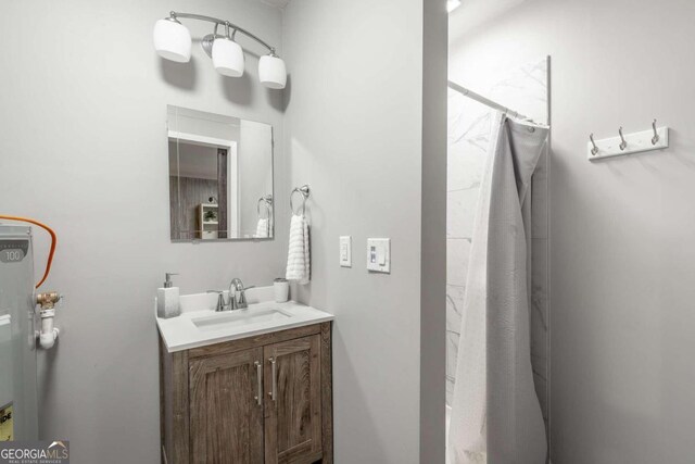 bathroom featuring walk in shower and vanity