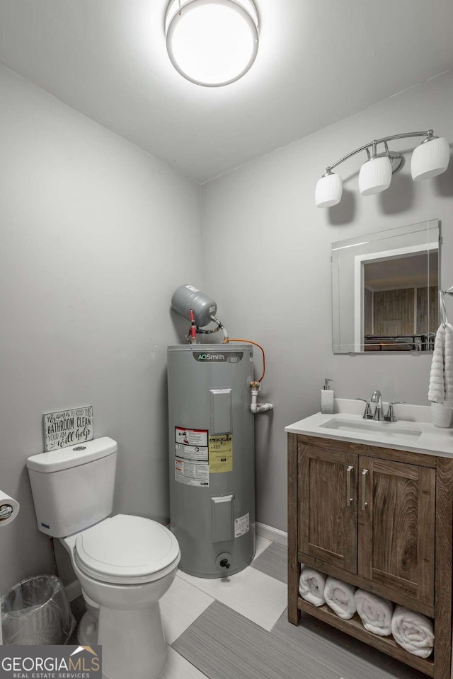 bathroom featuring water heater, vanity, and toilet