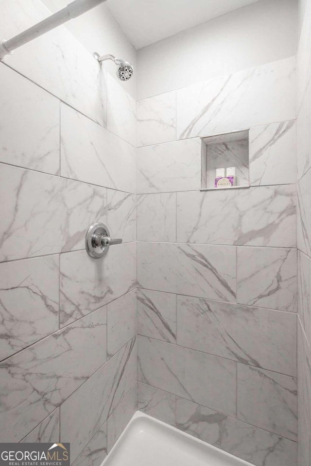 bathroom with a tile shower