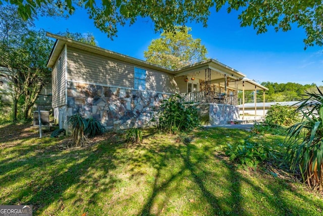 rear view of property with a yard