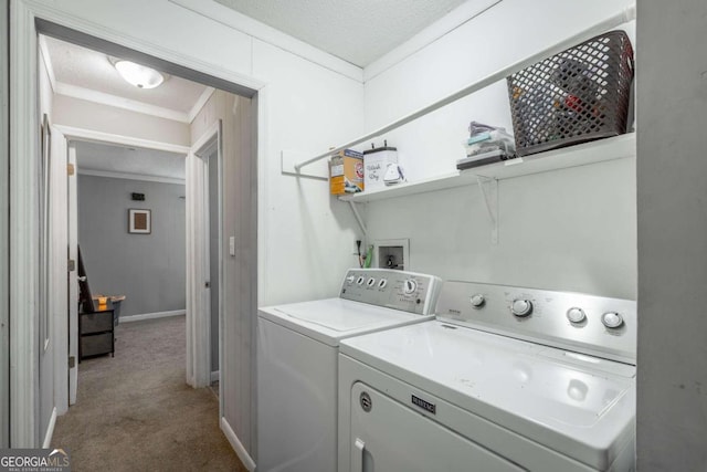 laundry area with washer and clothes dryer, carpet, a textured ceiling, and crown molding