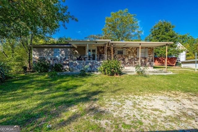 back of property with covered porch and a yard