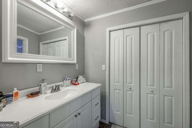 bathroom featuring vanity, a textured ceiling, and ornamental molding