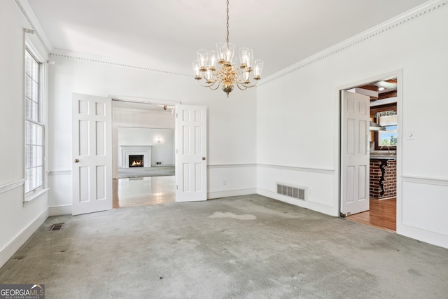 interior space with a chandelier and crown molding