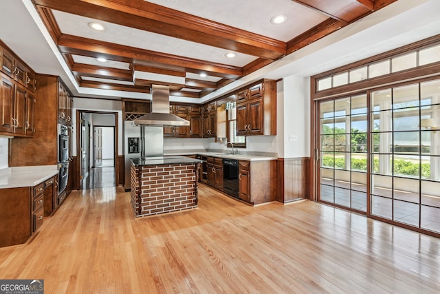 kitchen with island range hood, a kitchen island, beam ceiling, sink, and light hardwood / wood-style floors