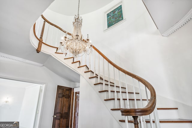 stairway featuring a towering ceiling and a notable chandelier