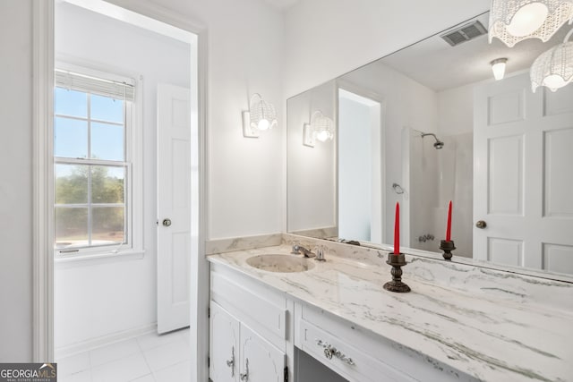 bathroom featuring a shower, vanity, and tile patterned floors