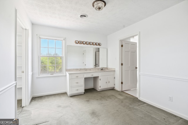 bathroom with vanity and a textured ceiling