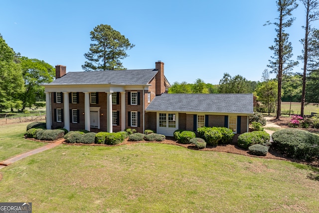 neoclassical / greek revival house with a front lawn