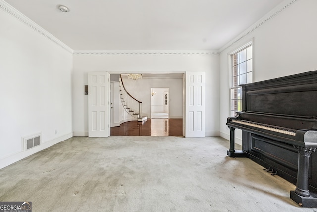 miscellaneous room with an inviting chandelier, carpet flooring, and crown molding