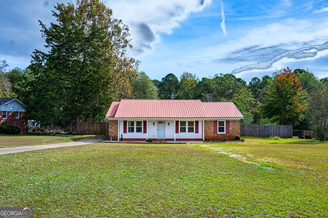 ranch-style home with covered porch and a front yard