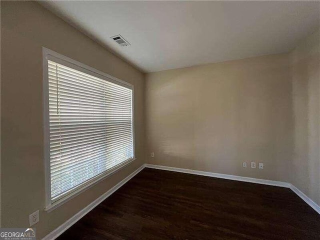 unfurnished room with dark hardwood / wood-style floors