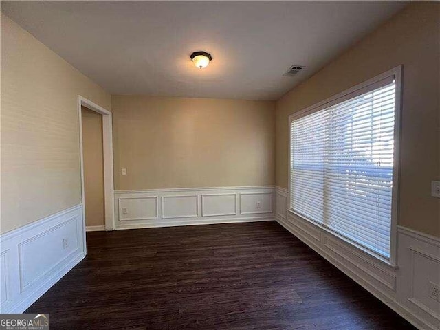 spare room with dark wood-type flooring