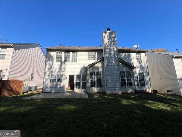 back of house with a patio and a yard