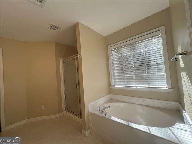 bathroom featuring shower with separate bathtub