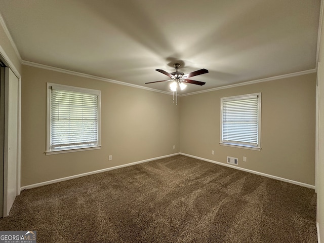 carpeted spare room with ceiling fan and crown molding