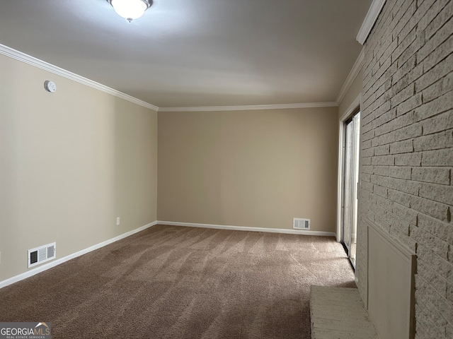 carpeted spare room featuring crown molding