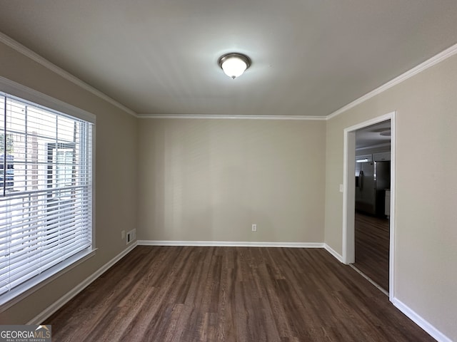 empty room featuring dark hardwood / wood-style flooring and crown molding