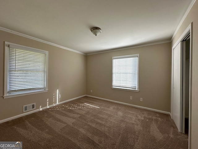 carpeted empty room with crown molding