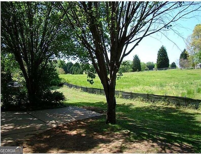 view of yard with a rural view