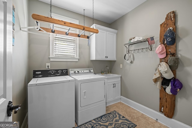 laundry room featuring cabinets, washer and dryer, and sink