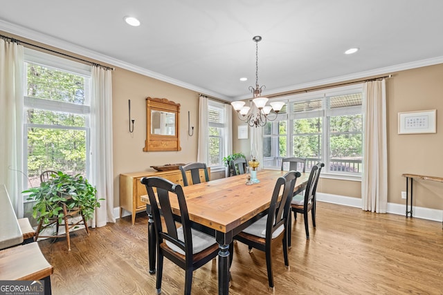 dining room featuring light hardwood / wood-style floors, a healthy amount of sunlight, and crown molding