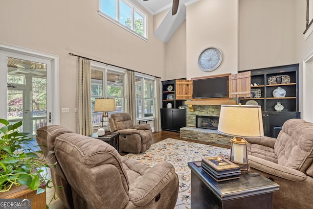 living room with a wealth of natural light, hardwood / wood-style flooring, and crown molding