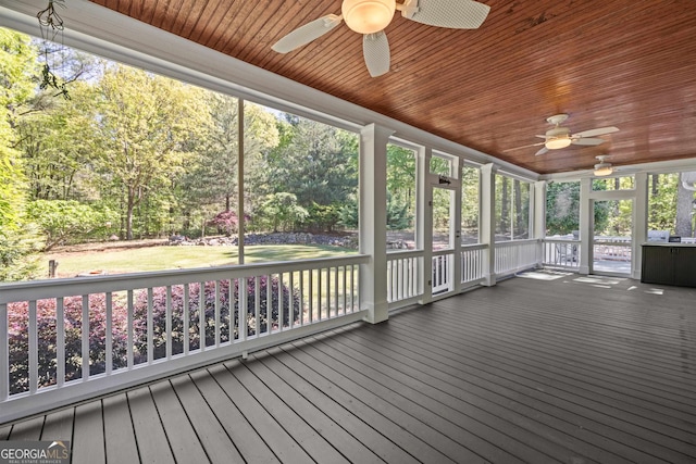 unfurnished sunroom with a wealth of natural light, ceiling fan, and wood ceiling