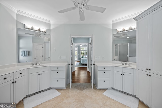 bathroom featuring ornamental molding, an enclosed shower, vanity, and ceiling fan